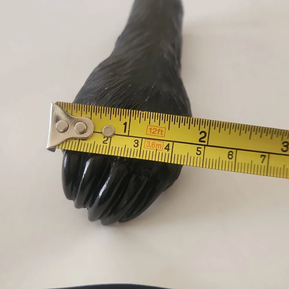 RESIN AND METAL BEAR PAW BOTTLE OPENER.
